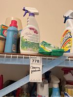 Top shelf showing multiple cleaning bottles and wipes with visible Arm & Hammer and Fantastik products.