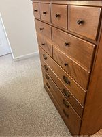 Photo showing the full dresser from an angle displaying drawer arrangement and handle types