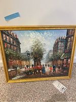 Front view of the framed vintage oil painting showing the full European street scene with people and flower stands.