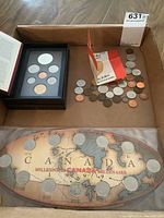 Lot view showing framed 1994 coin set, loose coins, and the 1999 Millennium coin set on a map board.