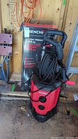 Front view of Benchmark 2100 PSI electric pressure washer with box in background