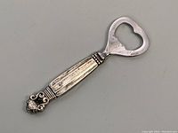 Full view of the 4.5 inch bottle opener showing the sterling silver handle and metal opener section.