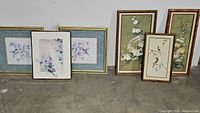 All six framed bird artwork paintings grouped on floor showing variety of frames and bird subjects