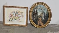 Both framed paintings side-by-side showing floral and nature scenes