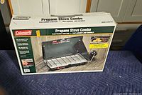 Boxed Coleman propane stove combo with product branding and image on packaging