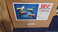 Box label showing Smith-Victor studio light models A198, A96, and A100 with brand and model information.