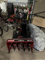 Front view showing red housing, auger, Craftsman branding and 26" label.