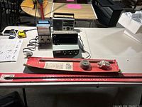 Full lot showing the electronics and antennas on a table with accessories and power cords