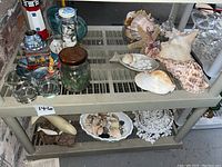 Overall lot display showing seashells, candle holder, jars, glasses, nautical decorations
