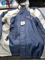 Full view of the navy, white, and silver NFL Patriots jacket front showing design and logo