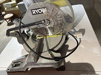 Ryobi chop saw side view showing scratch marks and cord