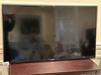 Front view of the 40-inch Samsung TV powered off, showing the screen and the bezel.