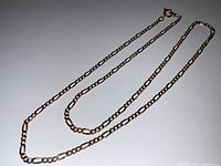 Chain laid flat on white surface showing overall length and link pattern