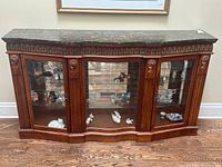 Front view showing entire credenza with marble top and glass doors