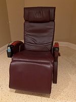 Front view of the burgundy massage chair upright position