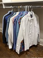 Overall rack view of men's long sleeve button-up shirts showing various colors and patterns