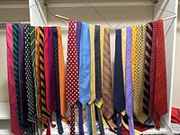 First group of ties hung across a rod showing full length of 27 ties
