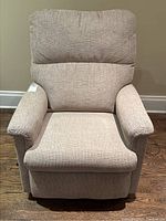Frontal view of the neutral tweed reclining chair showing seat, backrest and armrests