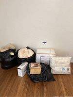 All bedding items and bags together including comforters, blanket, air mattress box, and sheets.