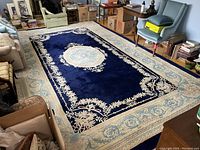 Full view of rug laid on hardwood floor in living room showing overall pattern and condition