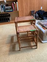 Photo showing both rattan tables stacked, displaying sizes and condition.