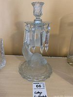 Front angle showing the scalloped rim candle holder and hanging prisms with the dolphin base.