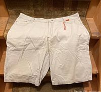 White corduroy shorts with front pockets and button closure