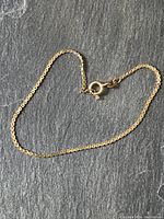 Overview of gold box chain bracelet laid flat