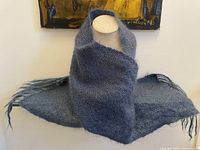 Scarf wrapped around a mannequin neck showing size and color pattern.