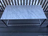 Full top view of rectangular marble table on metal frame