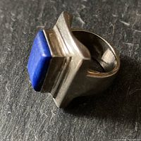 Angle showing thick sterling silver band and lapis lazuli stone bezel setting