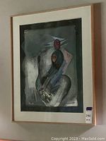 Framed art print with abstract figures in muted colors. Light wood frame and matting visible.