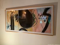 Full view of framed triptych on wall showing entire composition and frame