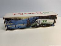 Side view of the original box with artwork depicting a Hess semi-truck and a winter skating scene.