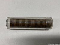 Front side of the coin tube with stacked wheat pennies inside.