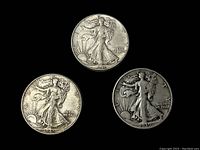 Three Walking Liberty half dollars front side showing dates 1941, 1945, and 1939-S, photographed on black background.