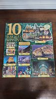 Full box cover showing 10 deluxe jigsaw puzzles with various images such as castles, wildlife, underwater scene, and architecture.