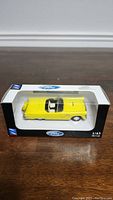 Yellow 1956 Ford Thunderbird 1/43 die-cast model in original packaging, front view showing details and branding