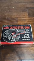 Top of the box for the Electric Car Defroster Gun showing branding and intended use, emphasizing safe winter driving and 12-volt compatibility.