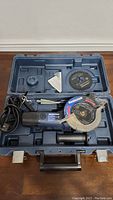 Mastercraft Twin Cutter power saw Kit in blue plastic carrying case with power cord, one blade attached and one spare blade.
