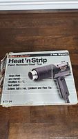 Box of Black & Decker Heat 'n Strip Paint Remover Heat Gun with product details visible.