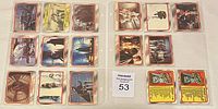 Photo showing 15 Star Wars collectible cards arranged in two rows in plastic sleeves, featuring characters, vehicles, and scenes from the original trilogy
