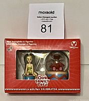 Front view of boxed Disney Our Family Tree mini snow-globe and figurine gift set in red packaging showing product clearly.