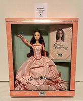 Full view of Barbie in original box showing pink gown, gloves and guide booklet