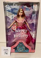 Front view of sealed Happy Birthday Barbie doll with packaging showing Barbie logo, doll in pink party dress, and visible blue tiara at bottom.