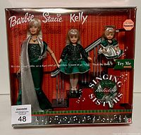 Full view of the sealed Holiday Singing Sisters Barbie Giftset in original box with three dolls in matching holiday outfits and stairwell prop.