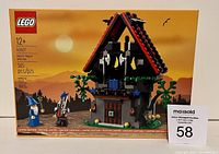 Front image of the unopened box showing the magical workshop exterior and two minifigures.