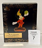 Ornament set box front with artwork showing Mickey Mouse holding a green bean. Black box with gold Disney Store and Sketchbook branding.