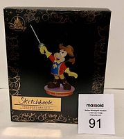 Boxed Disney Sketchbook ornament featuring Mickey Mouse in Three Musketeers costume.