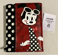 Front cover of Minnie Mouse journal showing cartoon image of Minnie with sunglasses, polka dot dress, and red jacket, next to a MAXSold auction card